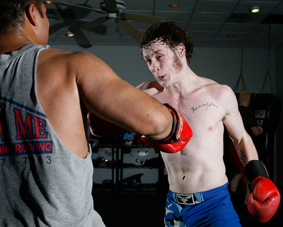 Kevin Croom (right) takes a swing at Eric Ward during an evening practice at the Hulett House Gym in Columbia, Mo. on April 7, 2009, three days before their Midwest Fight League contests at the Blue Note.  Croom said that in a week before a big event, he just wants to hit people.